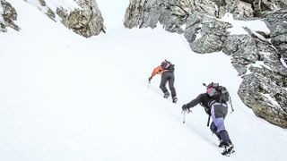 how to use an ice axe: mountaineers supporting themselves with their axe