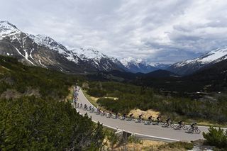 VALLE SPLUGA ALPE MOTTA ITALY MAY 29 Egan Arley Bernal Gomez of Colombia and Team INEOS Grenadiers Pink Leader Jersey The peloton passing through Passo San Bernardino 2065m mountains landscape during the 104th Giro dItalia 2021 Stage 20 a 164km stage from Verbania to Valle Spluga Alpe Motta 1727m Snow Alps UCIworldtour girodiitalia Giro on May 29 2021 in Valle Spluga Alpe Motta Italy Photo by Tim de WaeleGetty Images