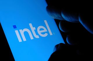 The Intel logo displayed on a smartphone being held