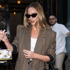 Margot Robbie wears jeans, pointed-toe boots and a blazer in New York.