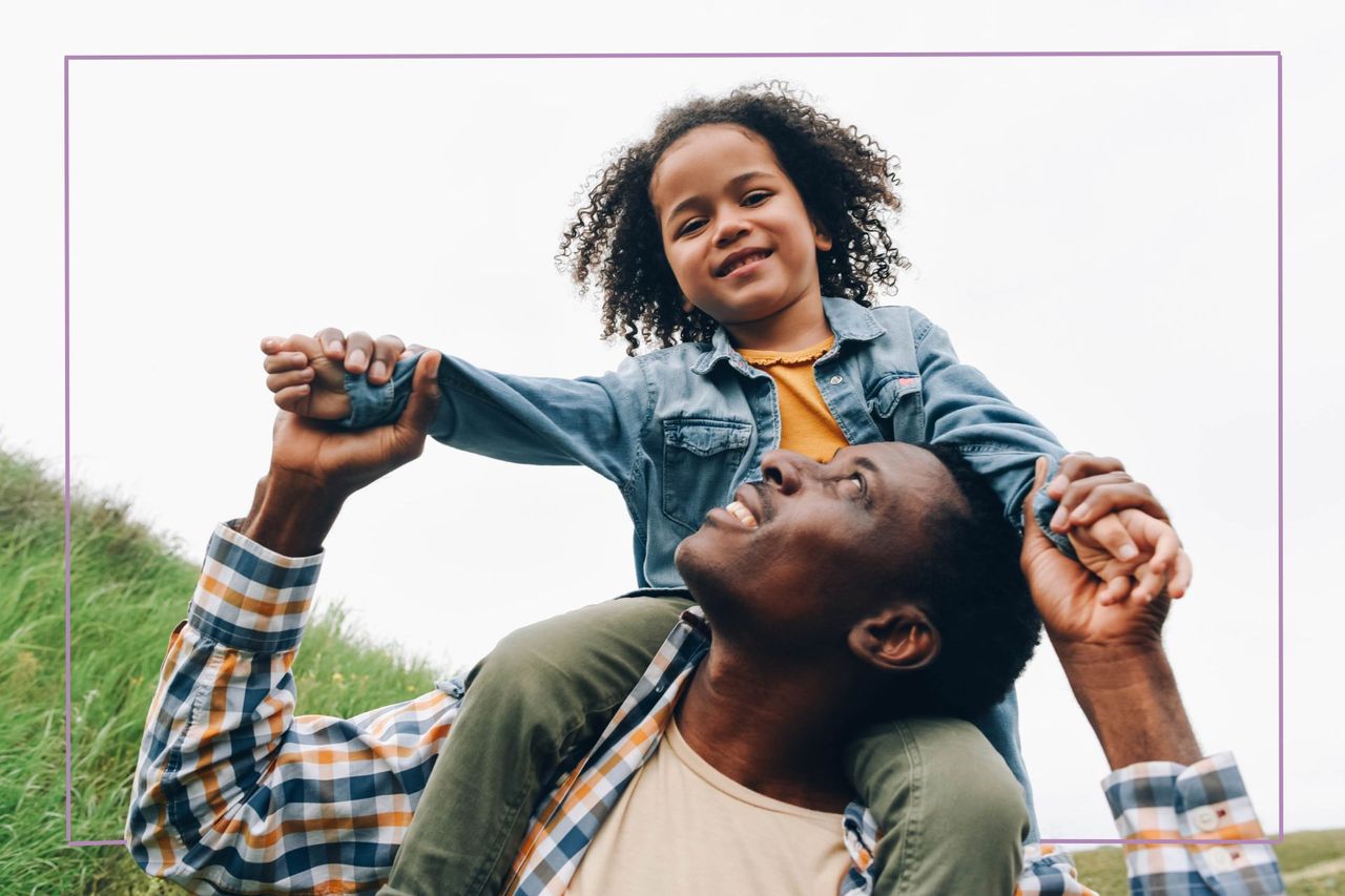 girl on man&#039;s shoulder holding hands