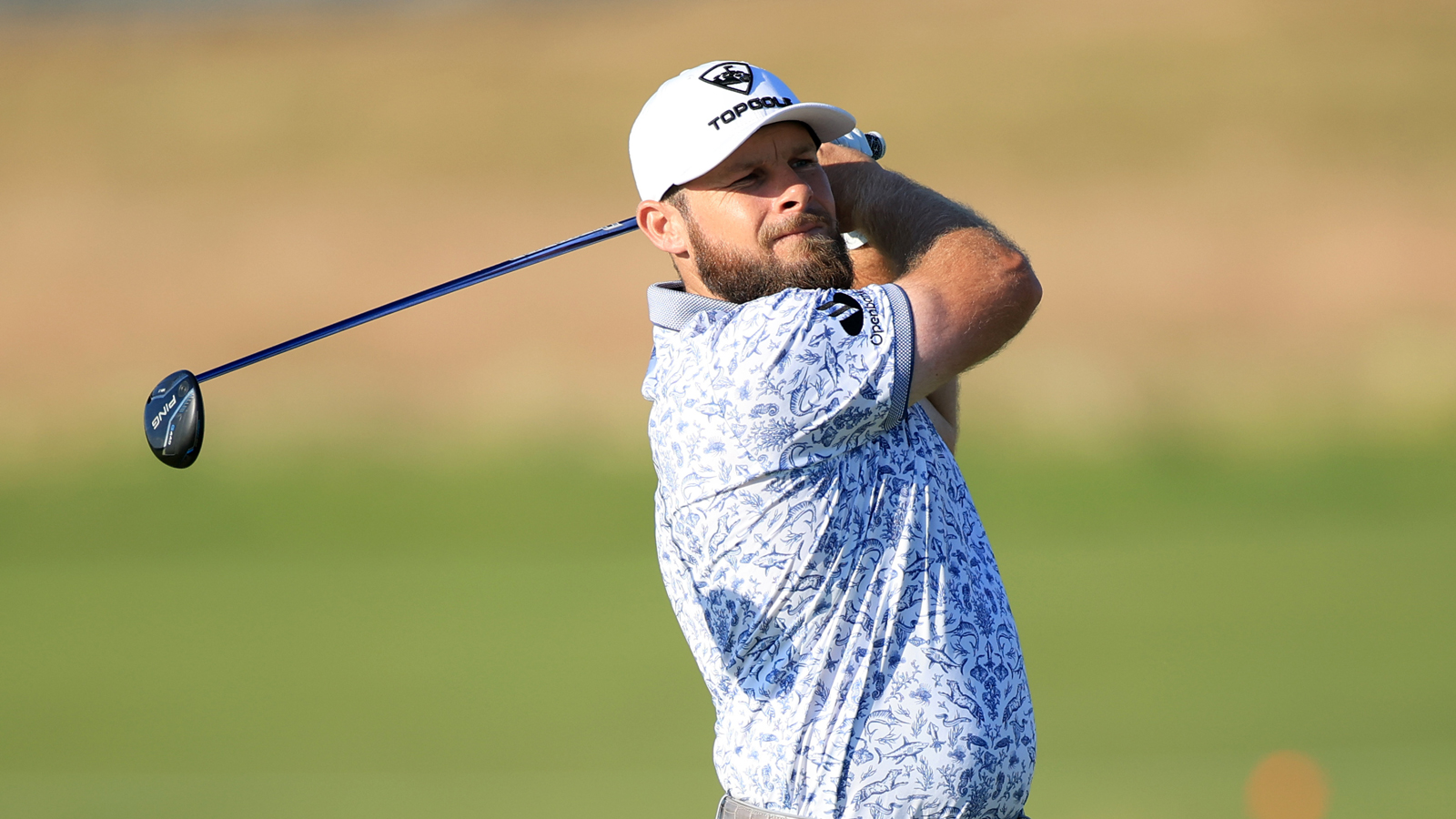 Tyrrell Hatton hits a fairway wood off the tee