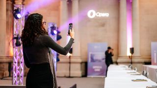 An Opera Browser Days attendee shoots a selfie video near an Opera logo