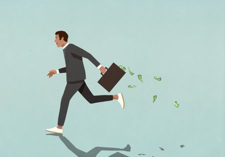 Man running away with suitcase full of money