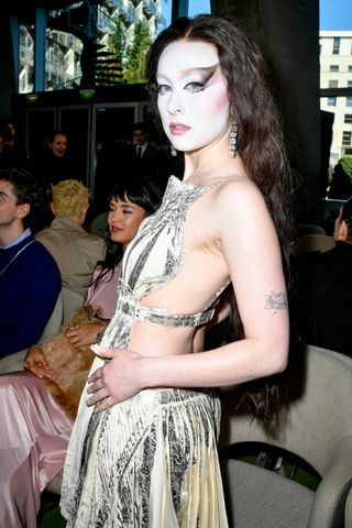 A photo of Chappell Roan wearing a silver metallic matching set to Rabanne's fall Paris Fashion Week show.