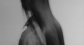 A black and white portrait of long hair