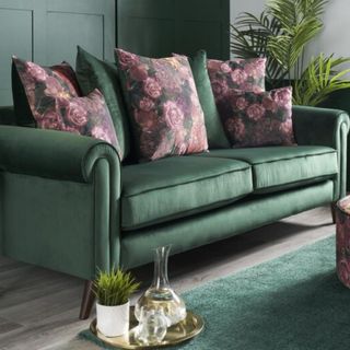 Green sofa with colourful cushions