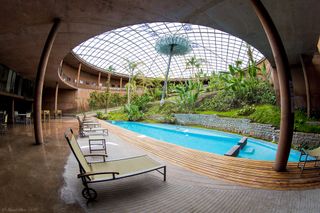 Residencia is the hotel designed by architectural firm Auer Weber for astronomers and staff at ESO's Paranal Observatory, which includes an enclosed tropical garden and a pool under a futuristic, domed roof.
