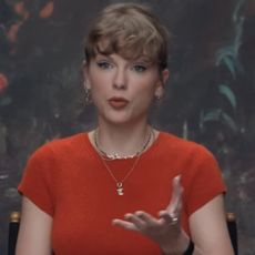 Taylor Swift wears a Showgirl orange Reformation cashmere sweater