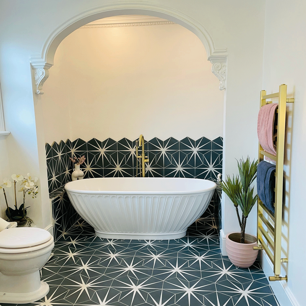 bathroom with white bath tub shower and potted plant