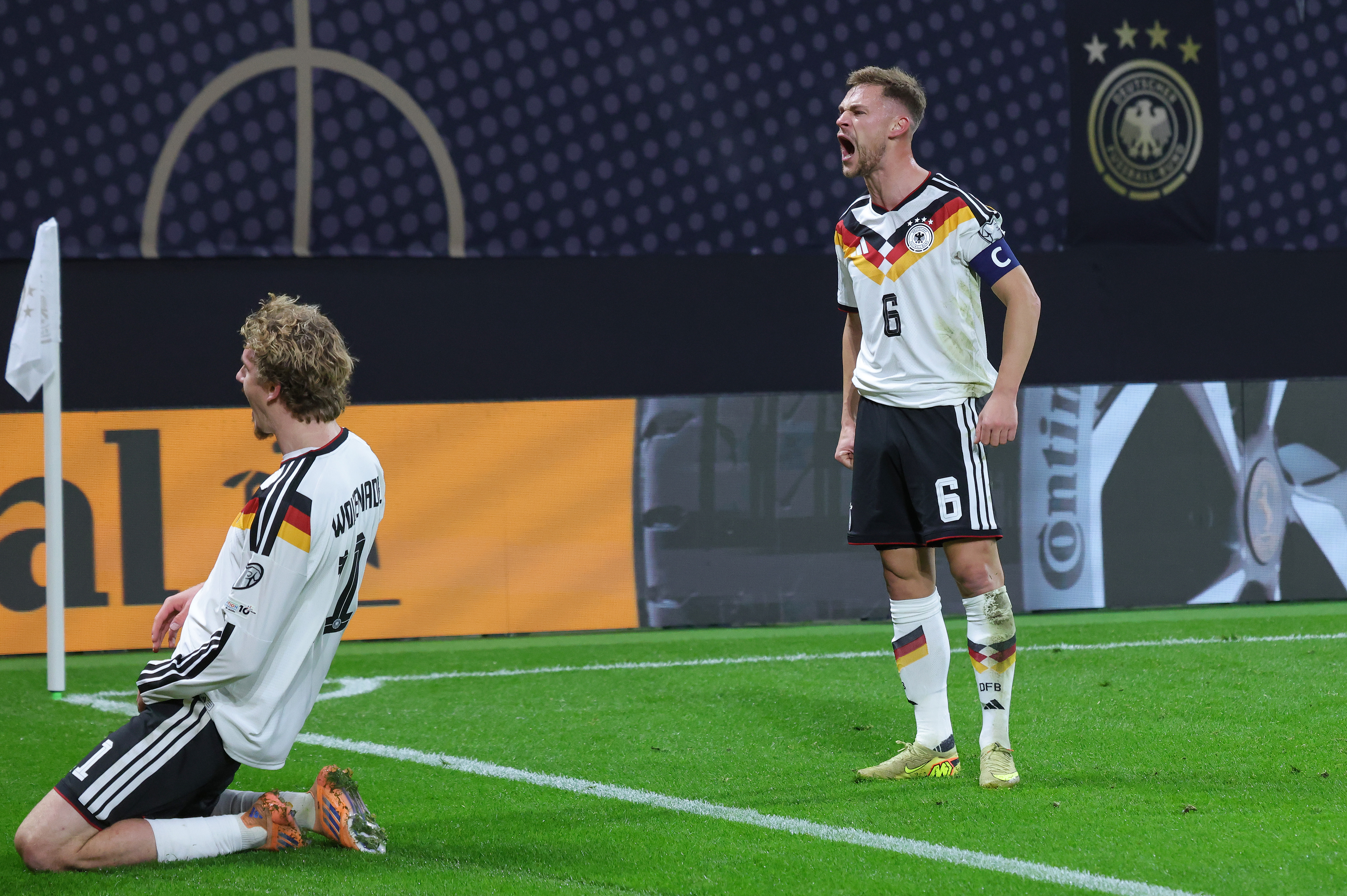 Nick Woltemade of Germany celebrates with teammate Joshua Kimmich (R) after scoring his team's first goal during the FIFA World Cup 2026 qualifier match between Germany and Slovakia at Red Bull Arena on November 17, 2025 in Leipzig, Germany.