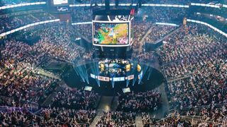 TOPSHOT - Attendees cheer and wave inflatable batons as they watch DRX compete against GEN during the League of Legends Worlds Championship semifinals at State Farm Arena in Atlanta, Georgia on October 30, 2022. (Photo by Elijah Nouvelage / AFP) (Photo by ELIJAH NOUVELAGE/AFP via Getty Images)
