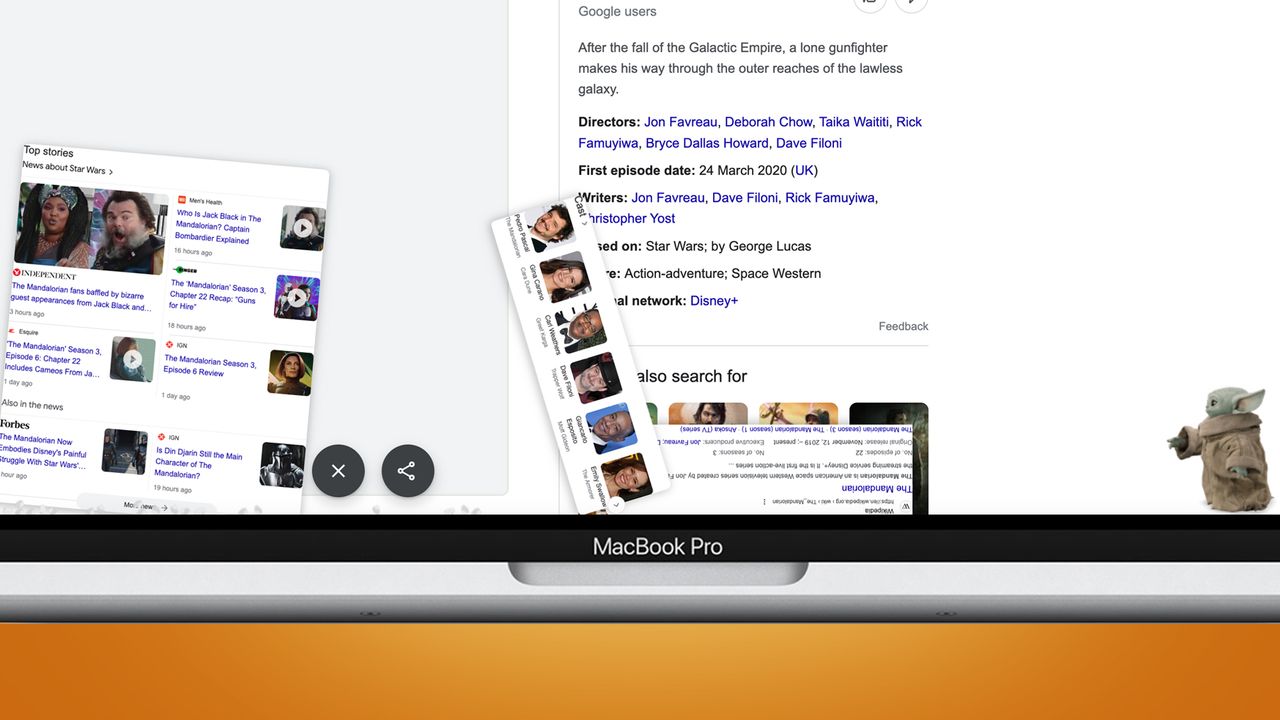 A laptop screen on an orange background showing a Google easter egg for The Mandalorian