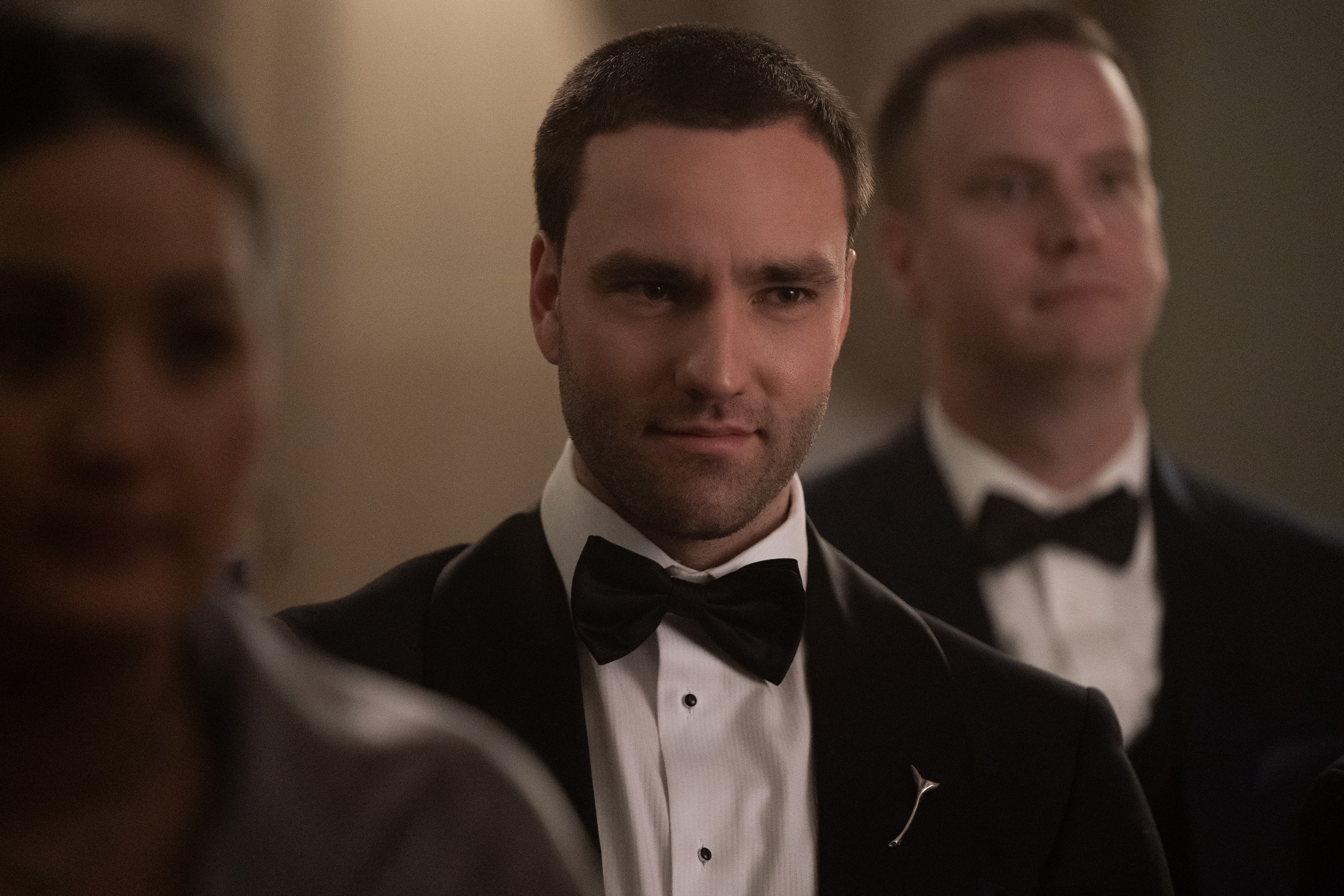 jackson white as stephen wearing a black suit and black bow tie at a wedding in tell me lies season 3