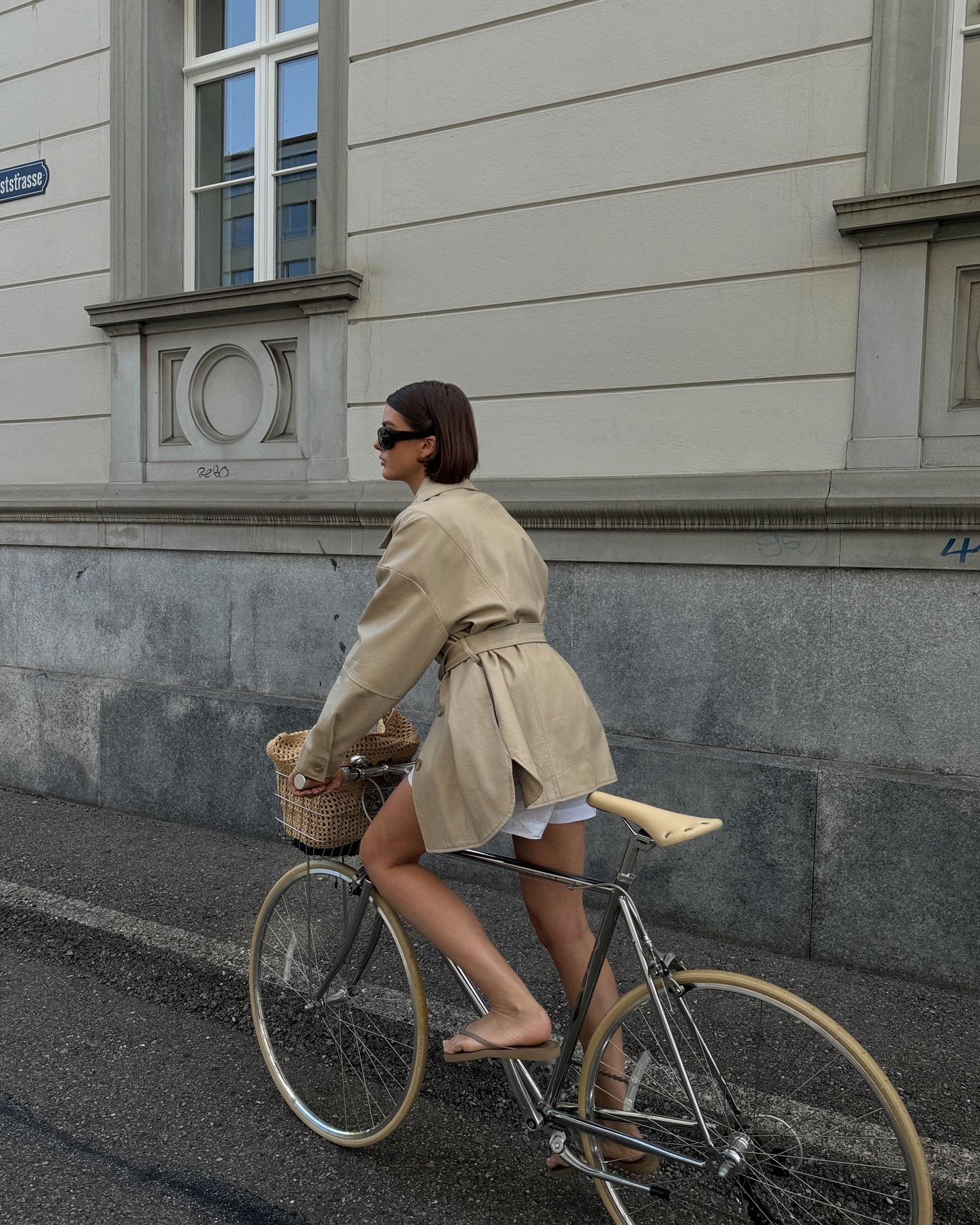 An image of @maryljean wearing a cropped trench coat, once of the biggest spring jacket trends to wear with dresses.