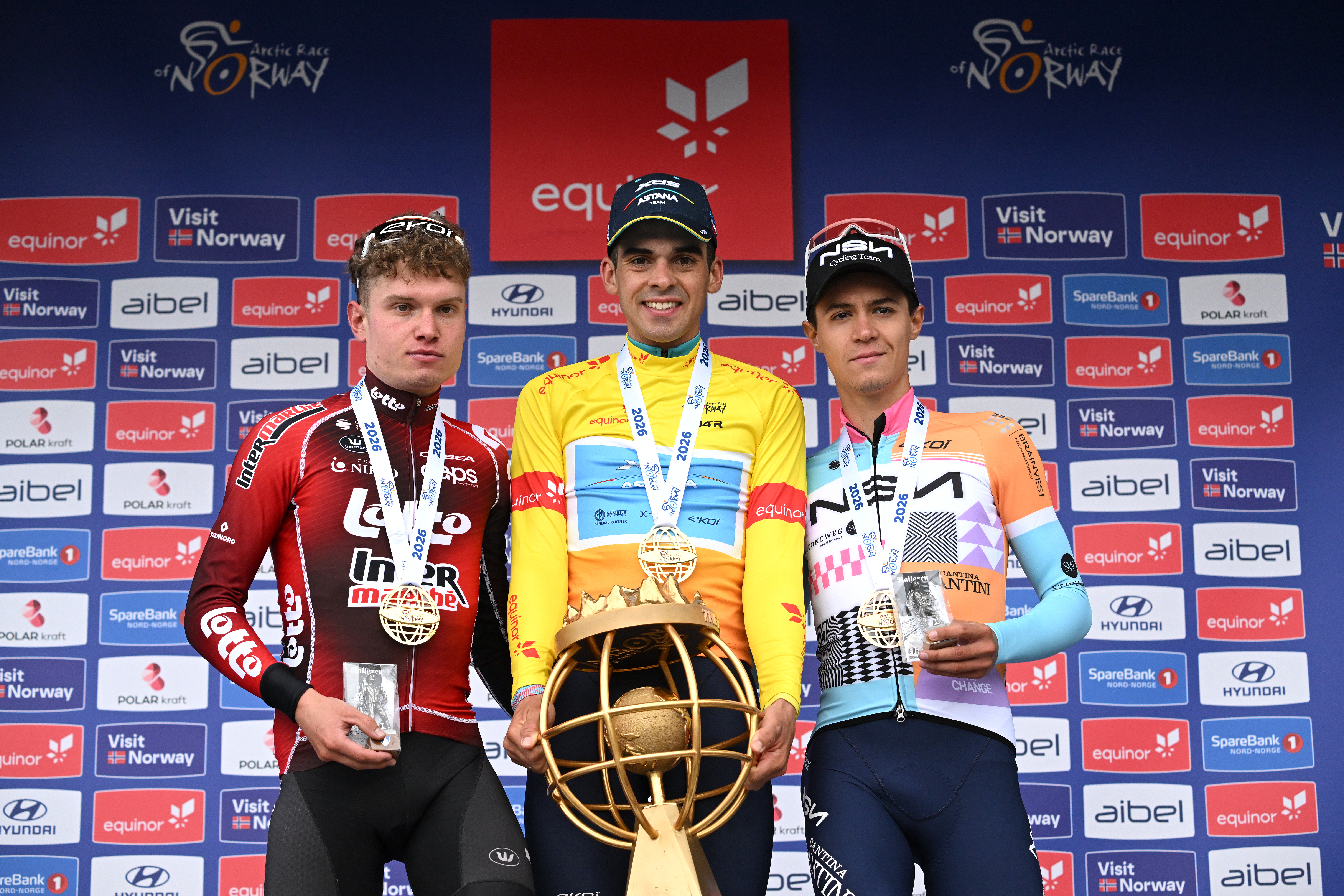 NARVIK, NORWAY - AUGUST 16: (L-R) Lennert Van Eetvelt of Belgium and Team Lotto Intermarche on second place, race winner Guillermo Thomas Silva of Uruguay and Team XDS Astana Team - Yellow Leader Jersey and Alessandro Pinarello of Italy and Team NSN Cycling Team on third place pose on the podium ceremony after the 13th Arctic Race of Norway 2026, Stage 4 a 190.5km stage from Sortland to Narvik 270m on August 16, 2026 in Narvik, Norway. (Photo by Dario Belingheri/Getty Images)
