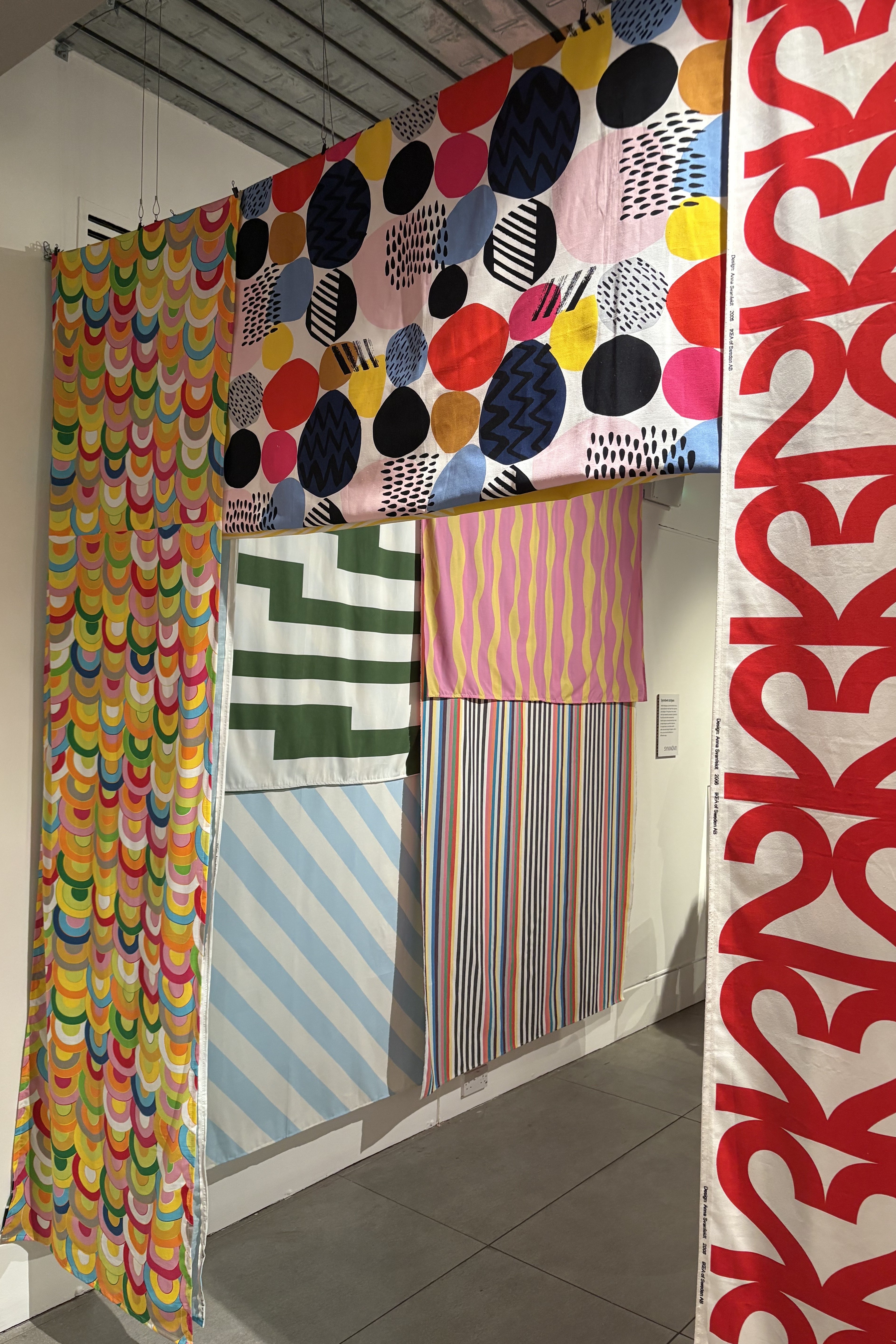 A colorful exhibition of patterned textiles.