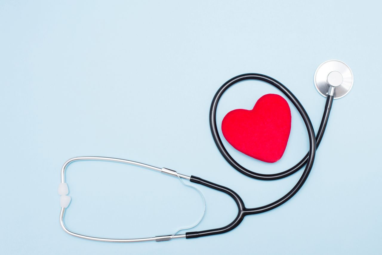 image of a stethoscope surrounding a rendering of a red heart shape