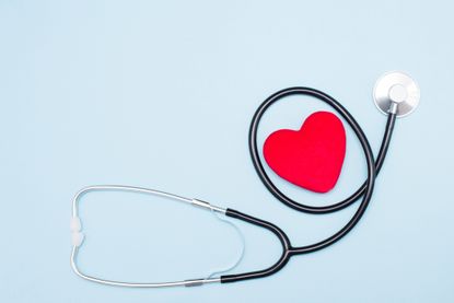 image of a stethoscope surrounding a rendering of a red heart shape