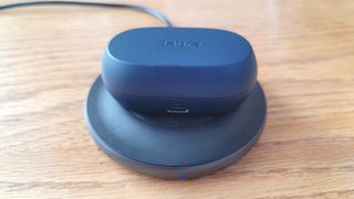 The Jabra Elite 7 Active charging on a wireless charging pad