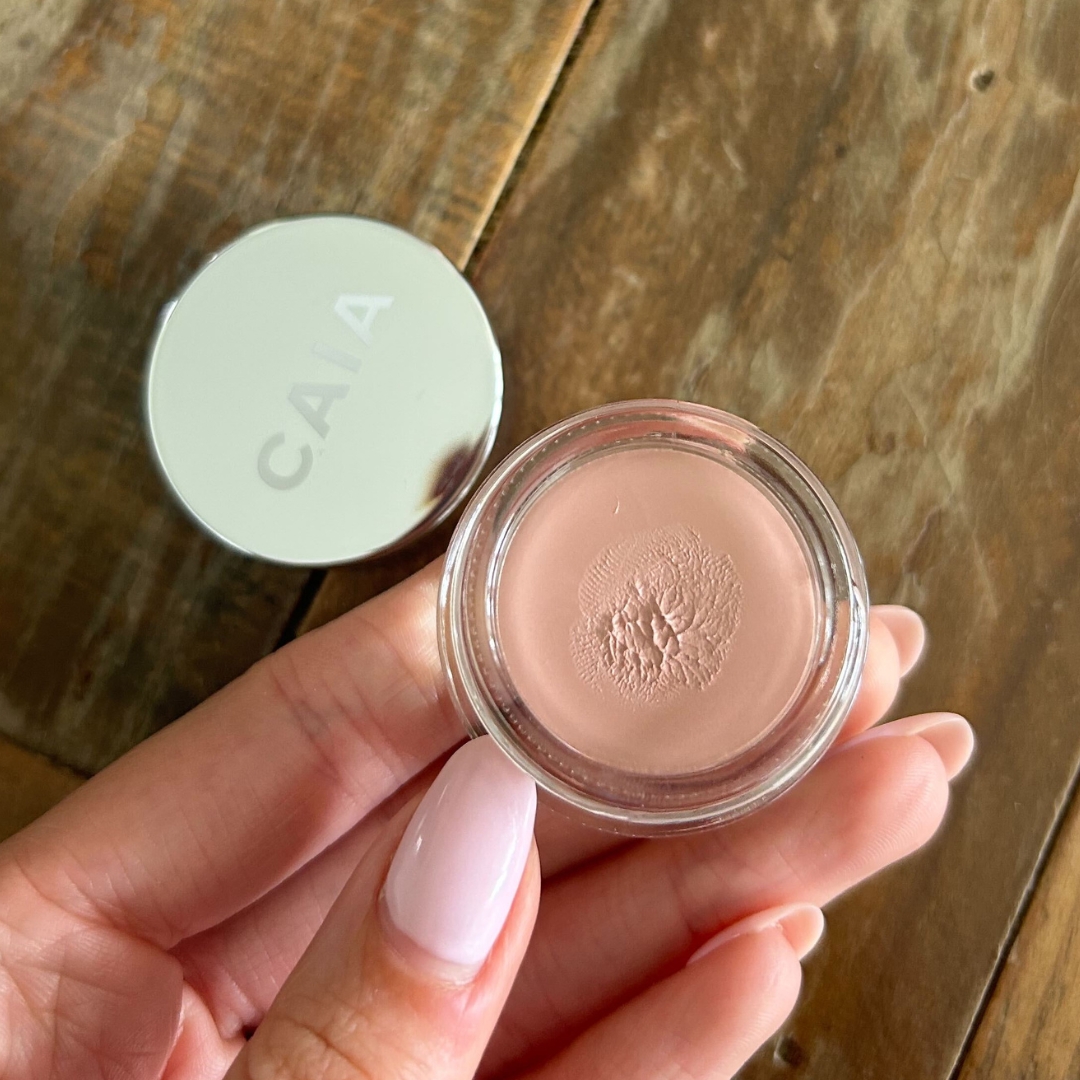 Hand holding the CAIA Wake Me Up Cream