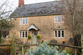 Grade II-listed cottage filled with vintage furniture and floral fabrics