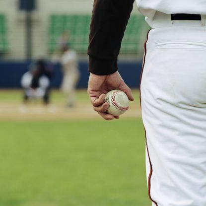 Pitcher on the mound holding a ball.