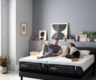 A man and a woman lying on the Tempur-Pedic ProAdapt Mattress.