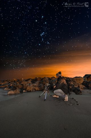 Night sky photographer Jon Secord is seen photographing the breakwater and night sky on the beach of Wallis Sands State Park in Rye, N.H. on Dec. 28, 2013 as constellation Orion passed overhead. This image was captured by Aaron Priest of Maine.