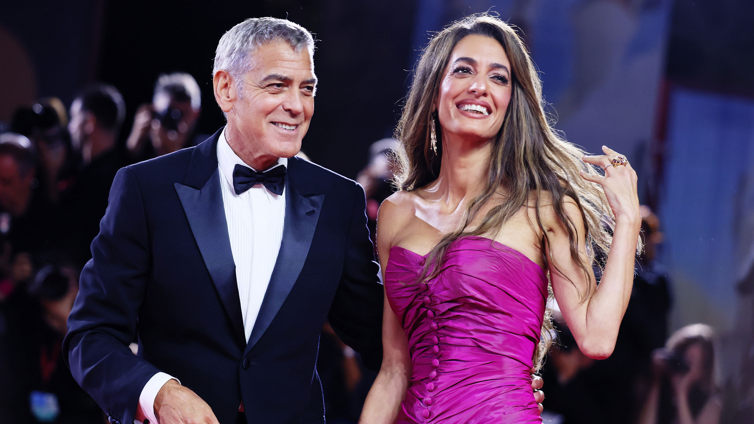 Amal Clooney wears the controversial high-low dress trend on the red carpet in a purple gown
