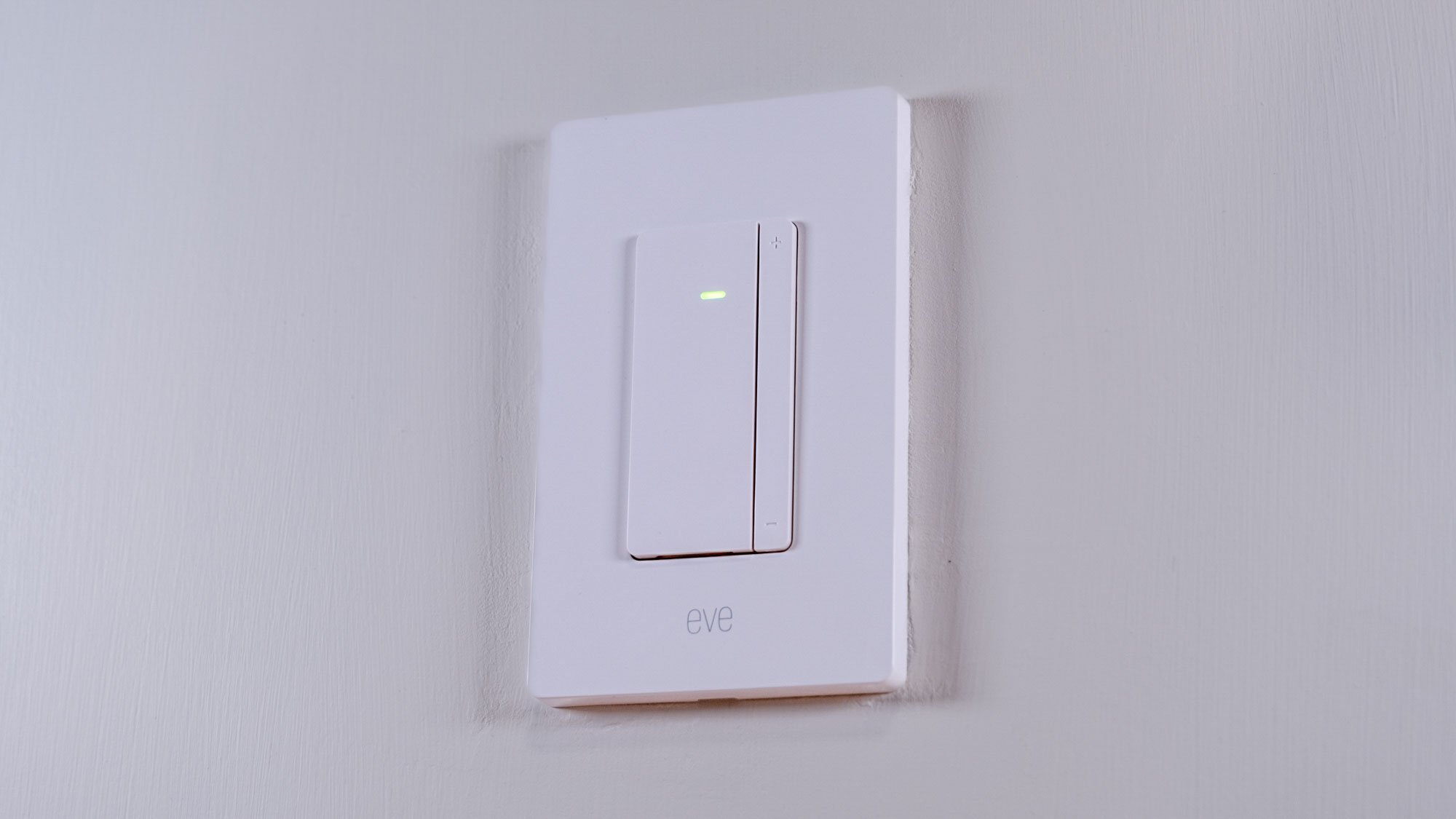 The Eve Dimmer Switch mounted on a white wall