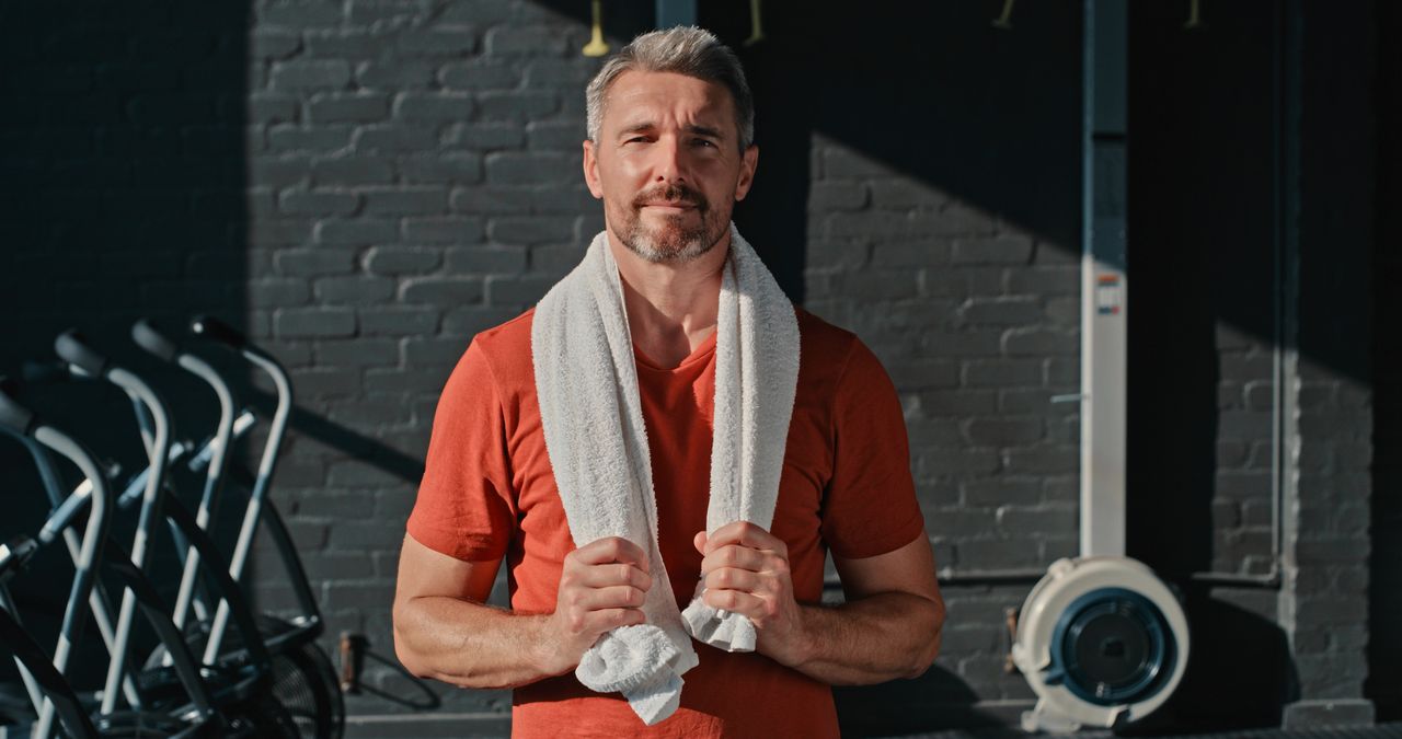 Shot of a handsome mature man standing alone after his workout in the gym.