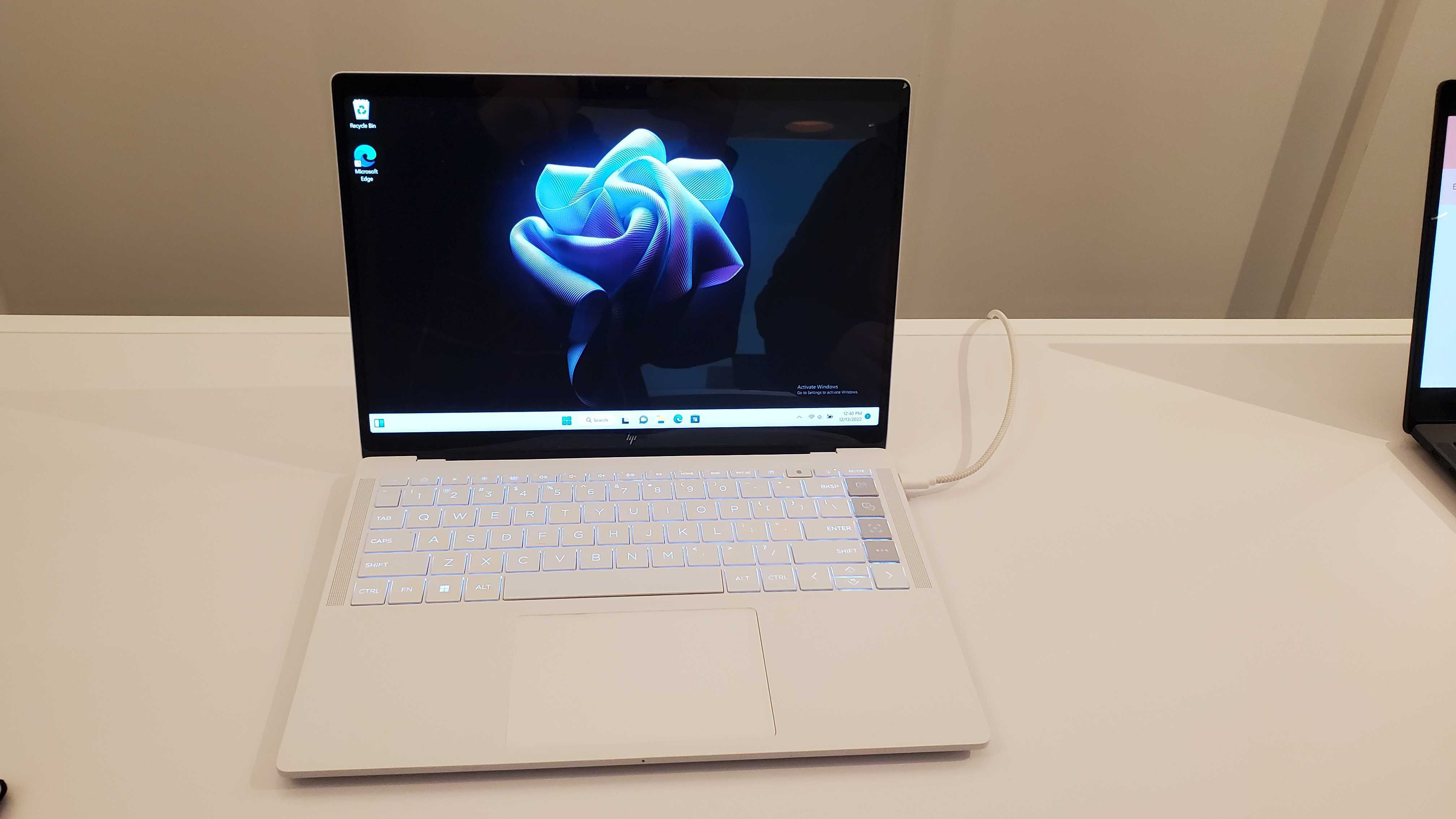 white HP Dragonfly Pro with flower background