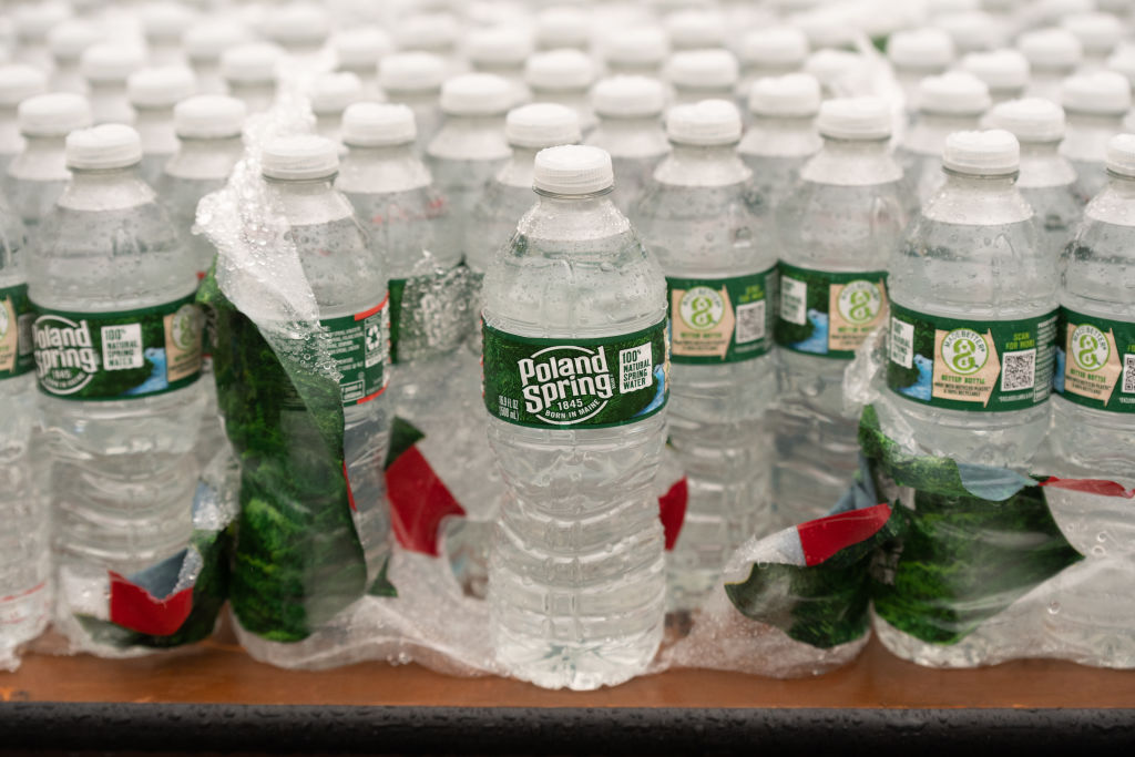 Raindrops collect on Poland Spring water bottles on a table in the finish line area of the B.A.A. Half Marathon on November 13, 2022