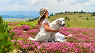 Woman and dog in field of flowers