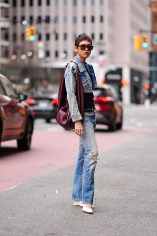 Woman at Fashion Week wearing a cropepd denim jean jacket