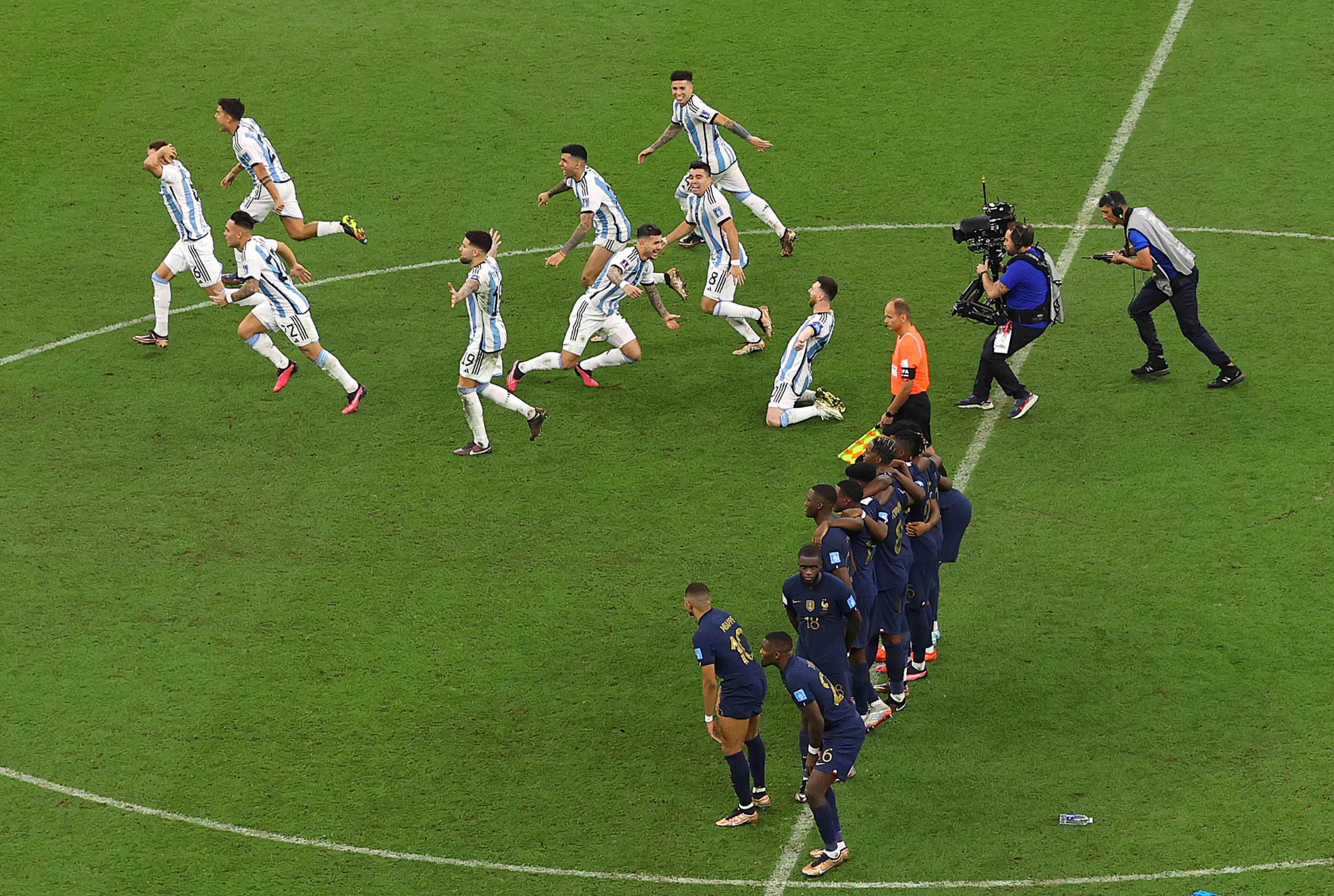 Argentina players run to celebrate after beating France on penalties in the 2022 World Cup final.