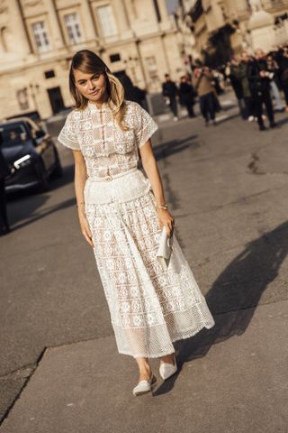 A woman wearing a white lace sheer skirt during Fall Winter 2024, Ready to Wear fashion week
