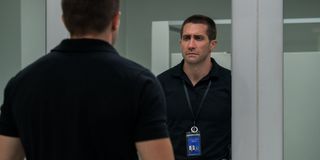 Jake Gyllenhaal looks at himself in the mirror sadly in The Guilty.