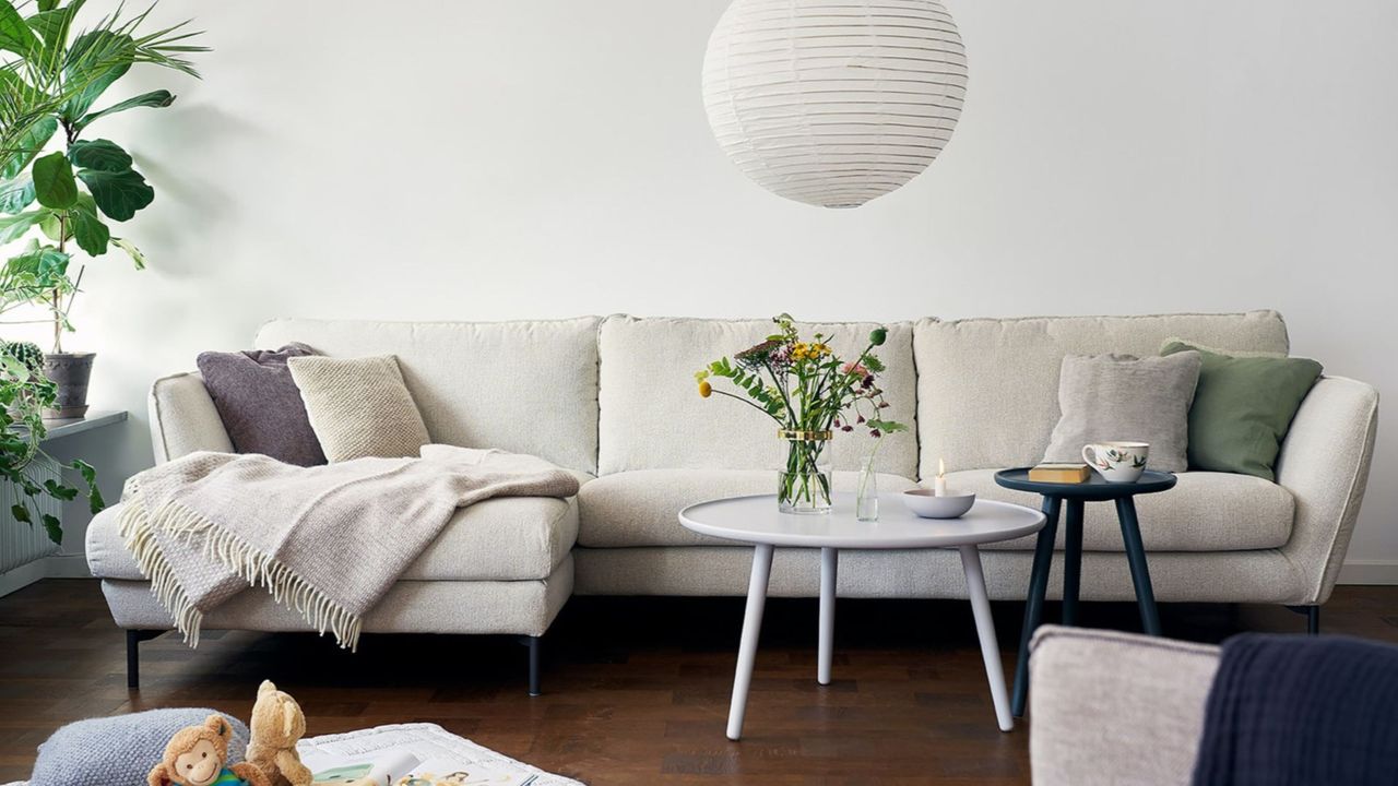 White corner sofa on wooden floor with white coffee table