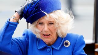 Camilla, Queen Consort holds onto her hat in the wind as she attends the 2023 Commonwealth Day Service at Westminster Abbey on March 13, 2023 in London, England. The Commonwealth represents a global network of 56 countries, having been joined by Gabon and Togo in 2022, with a combined population of 2.5 billion people, of which over 60 percent are under 30 years old.