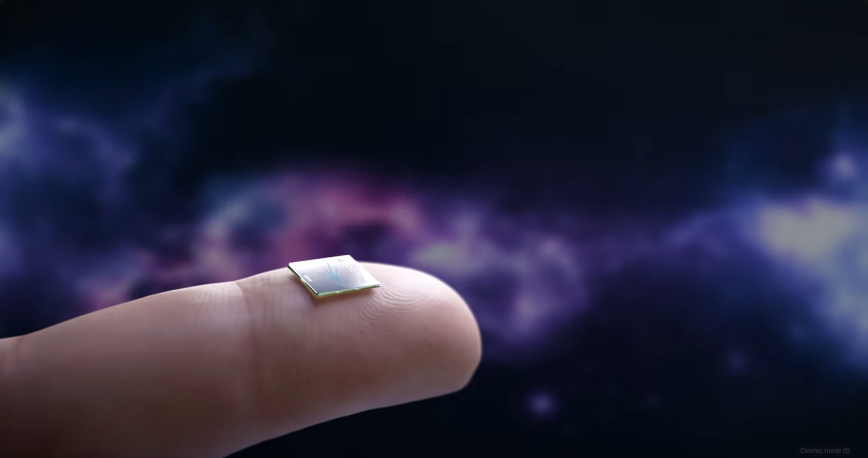 A tiny microchip labeled "xMEMS" rests on the tip of a person's finger, set against a colorful, cosmic-style background. 