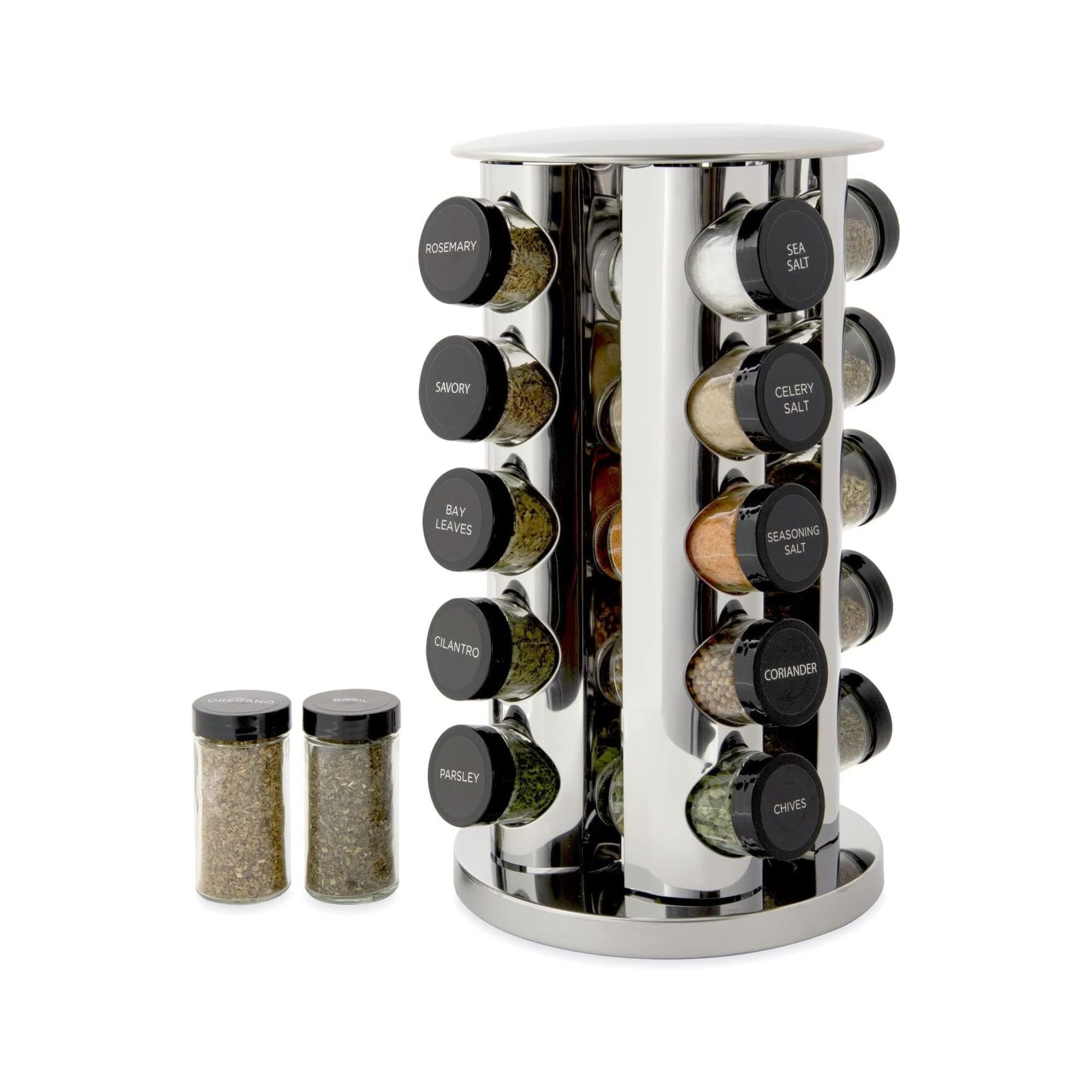 A stainless steel revolving spice rack with spices next to it.