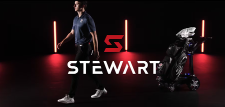 A man walking away from an electric trolley made by Stewart Golf