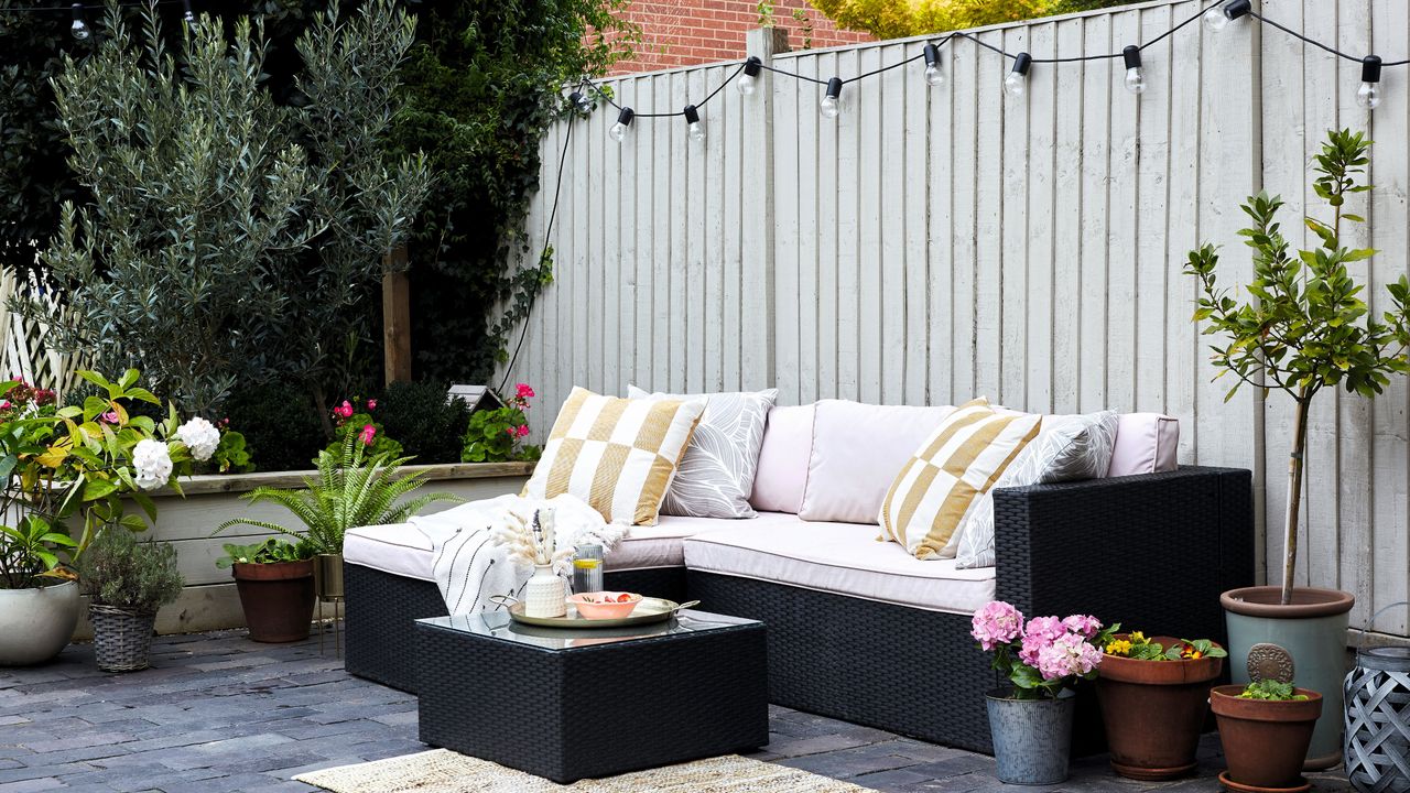 White wooden painted fence in outdoor living room garden area