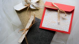 Three festive envelopes tied with god ribbon