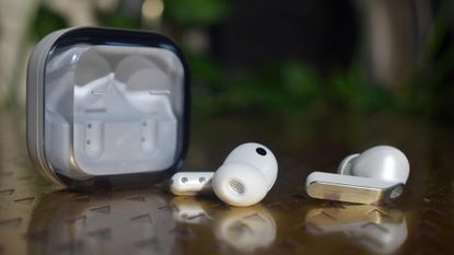 The Samsung Galaxy Buds 4 Pro on a table, next to the case.