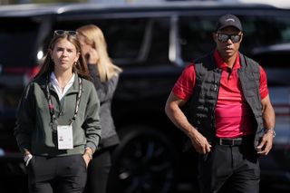 Kai Trump and Tiger Woods walk alongside each other at the Genesis Invitational