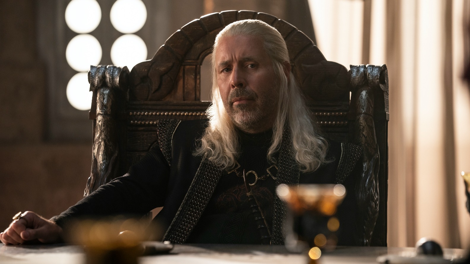 King Viserys I of Paddy Considine sits at the table to discuss matters in the House of the Dragon