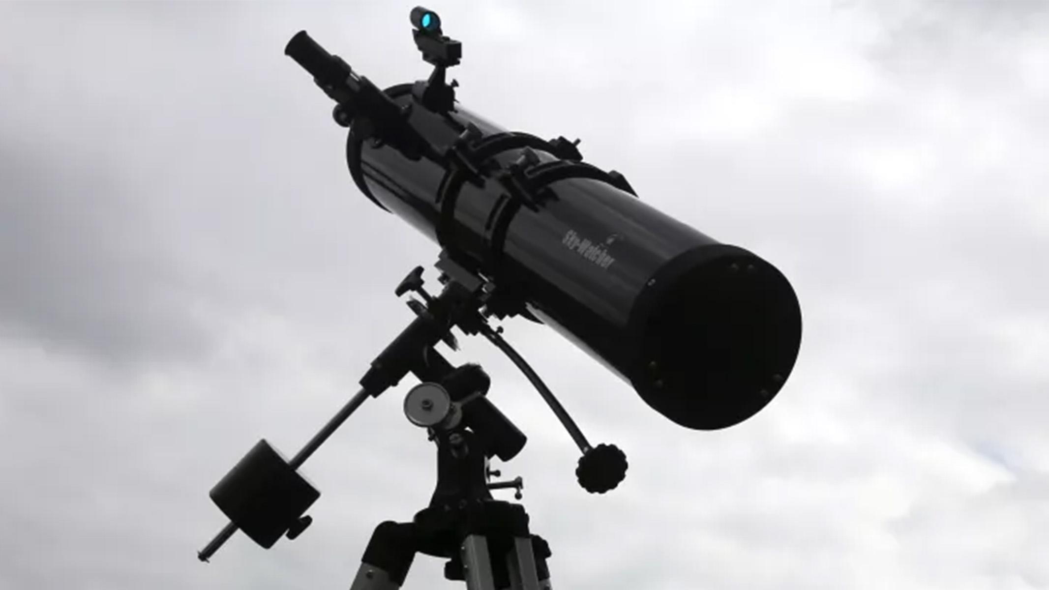 The Sky-Watcher Explorer 130 EQ2 telescope outside with a backdrop of clouds